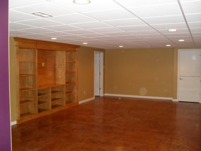Finished Basement, built in entertainment cabinet and acid stained floors