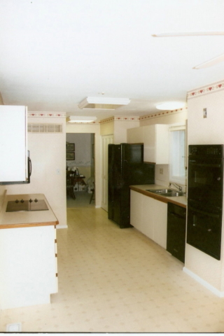 Opposite end of galley kitchen remodel before any work has begun.